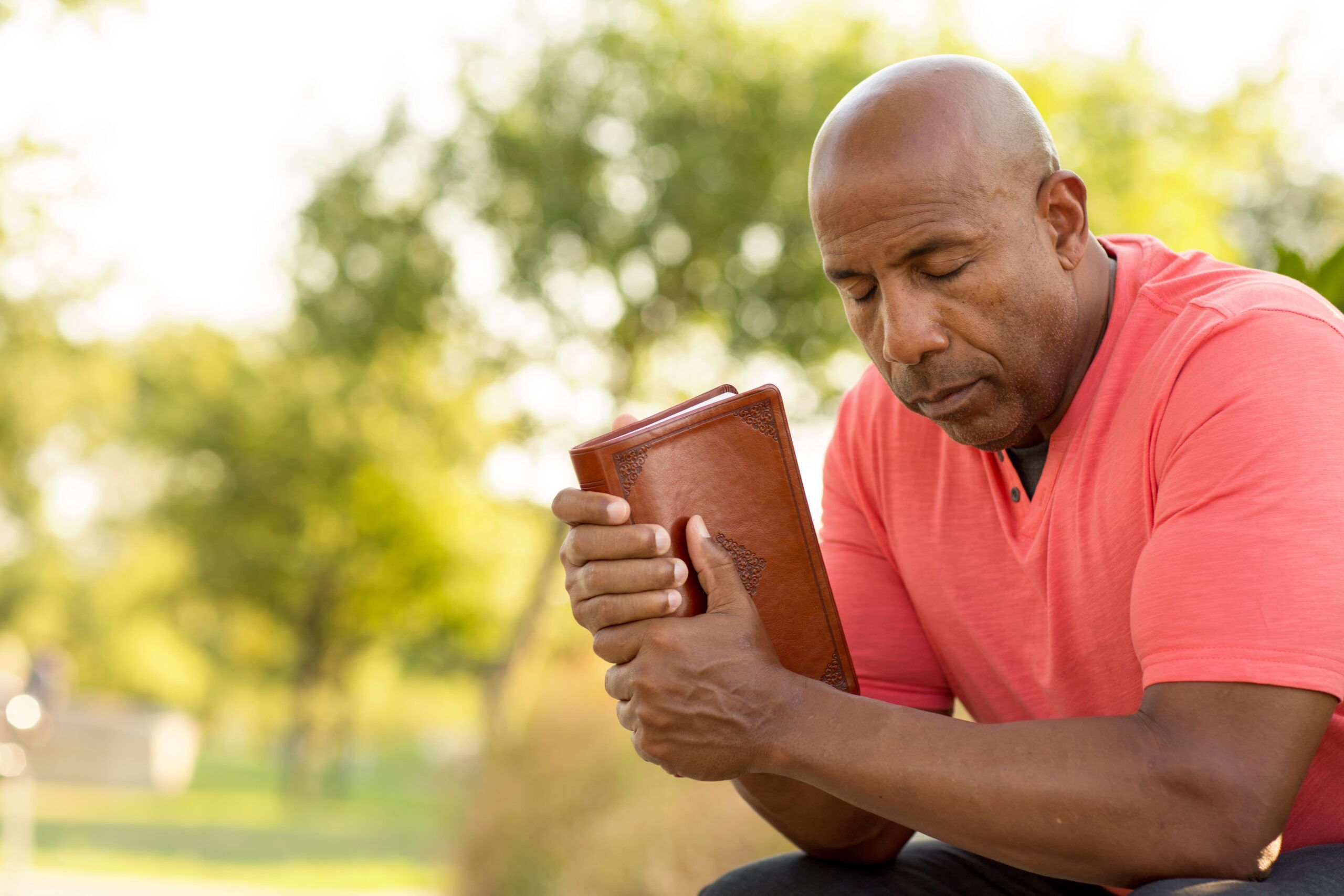 A man prays with his bible in hand during rehab near La Vergne, TN