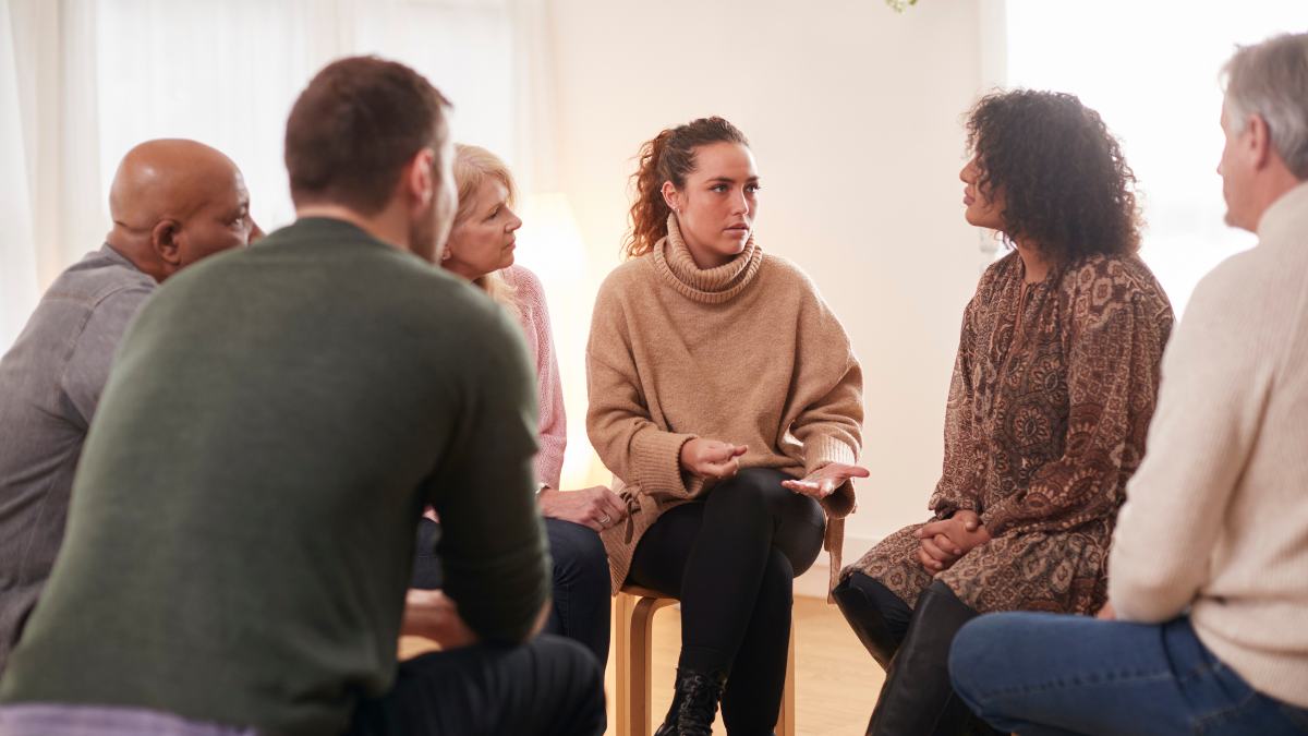 People discussing how to help a loved one with addiction during intervention.