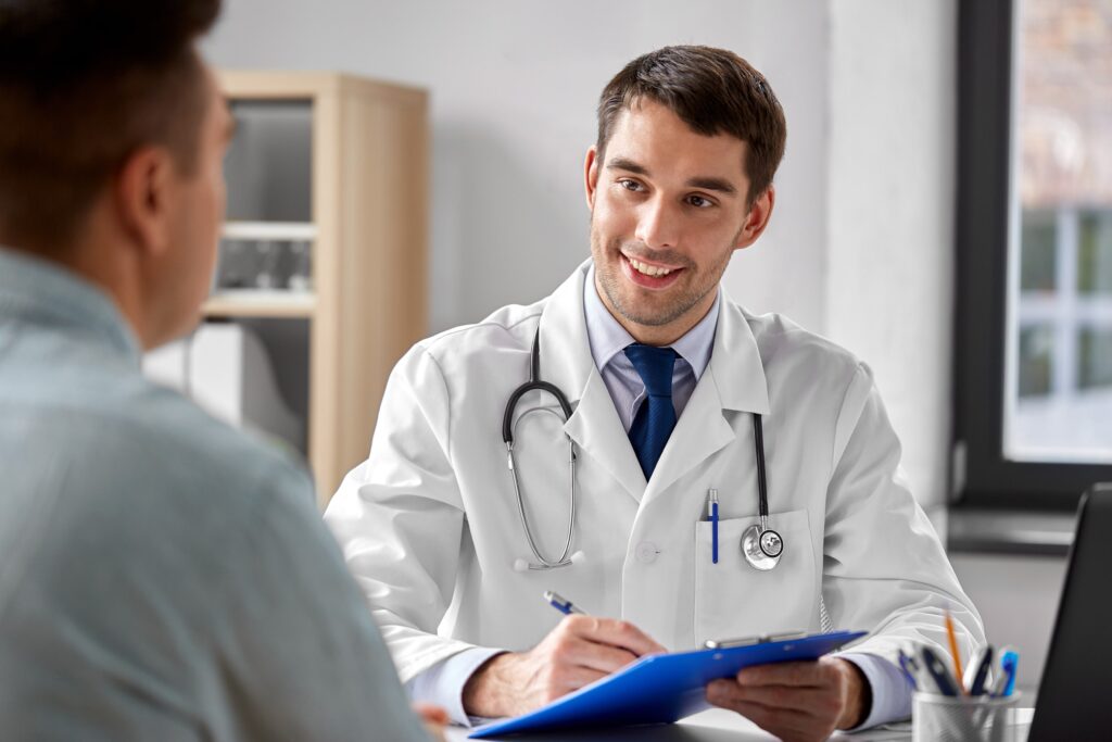 A man talks to his doctor about treatment.